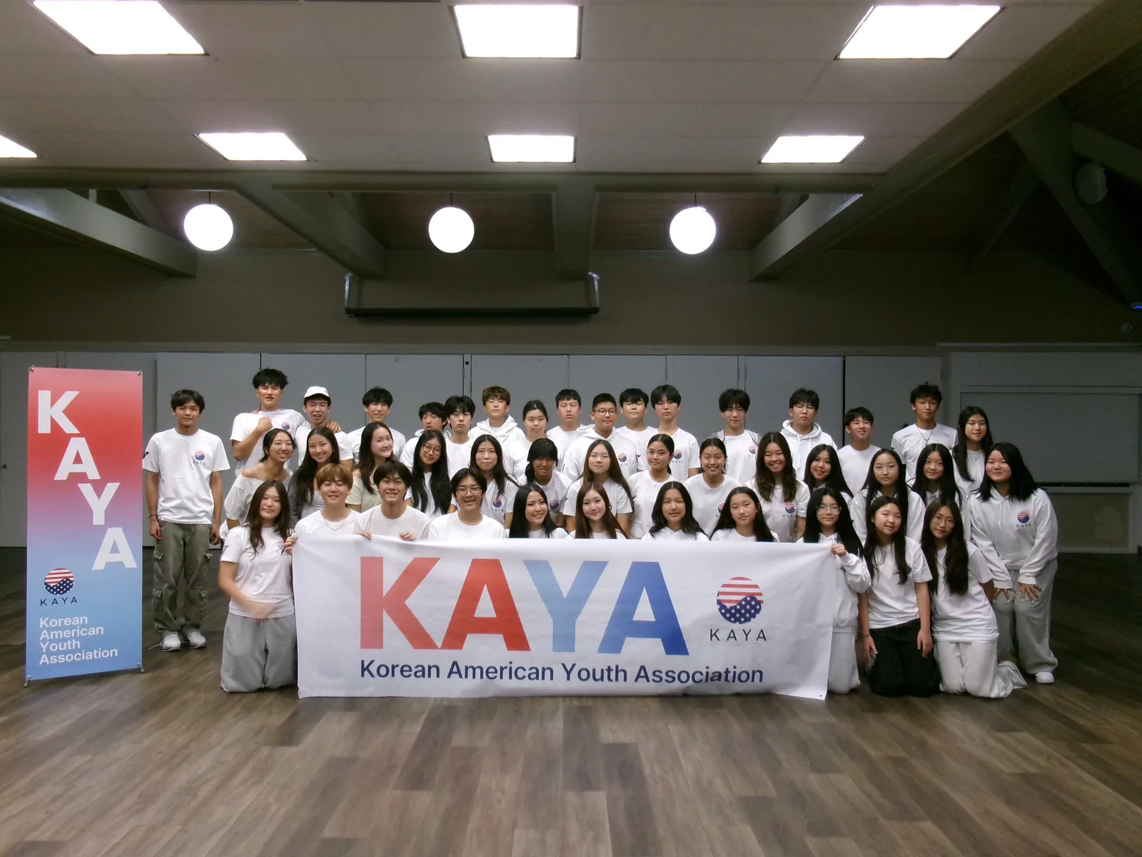 KAYA members together with the banner